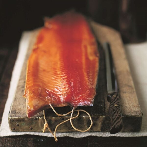 Whole side of smoked salmon on board