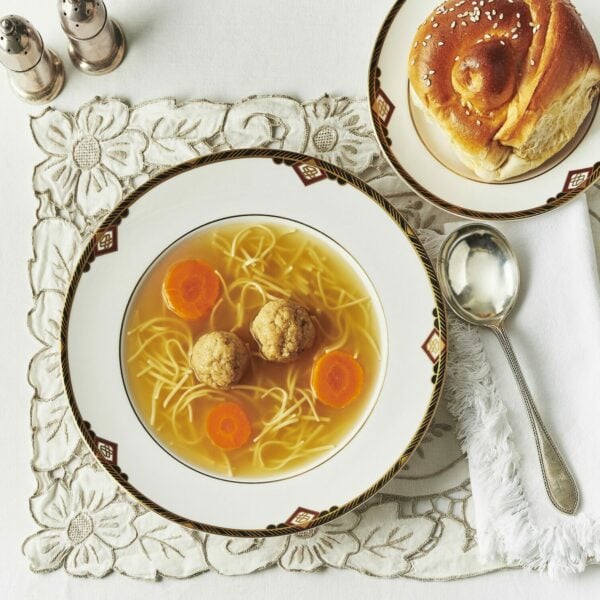 Traditional Jewish chicken soup with matzo ball and lockshen noodles